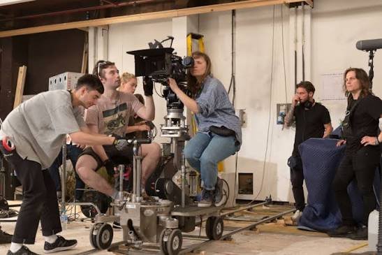 Cinematographer operating a professional movie camera